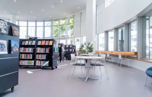 The refurbished circular atrium in the Ballarat Library at Doveton Street features a circular table right around the space, with scattered tables and chairs amongst the bookcases. 