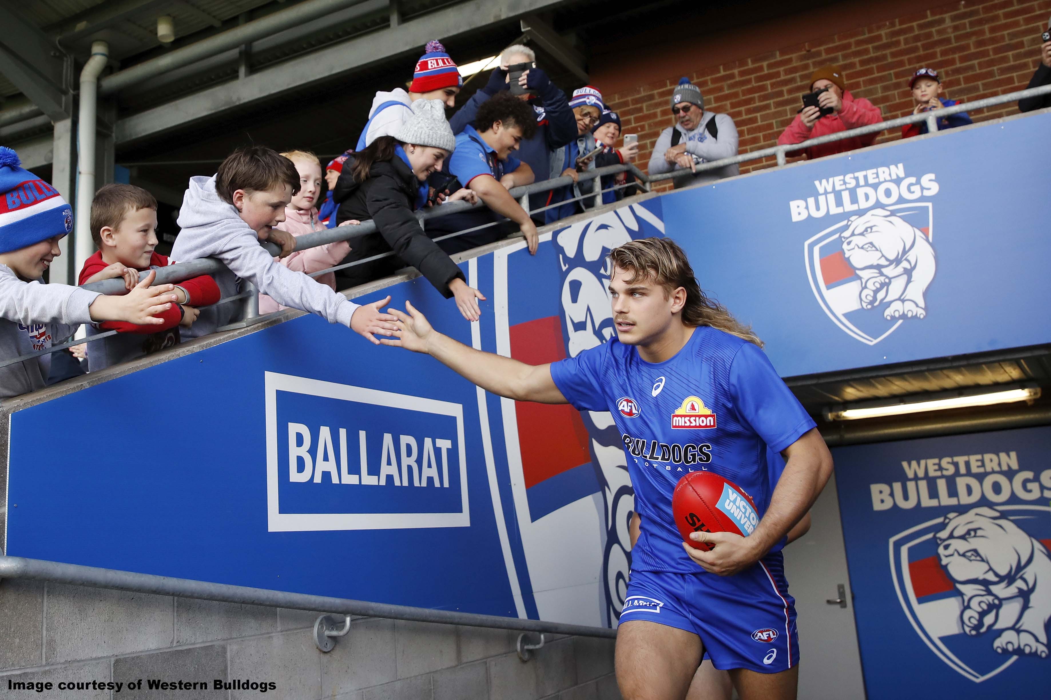 Western Bulldogs' Bailey Smith running out onto Mars Stadium in front of Ballarat sign