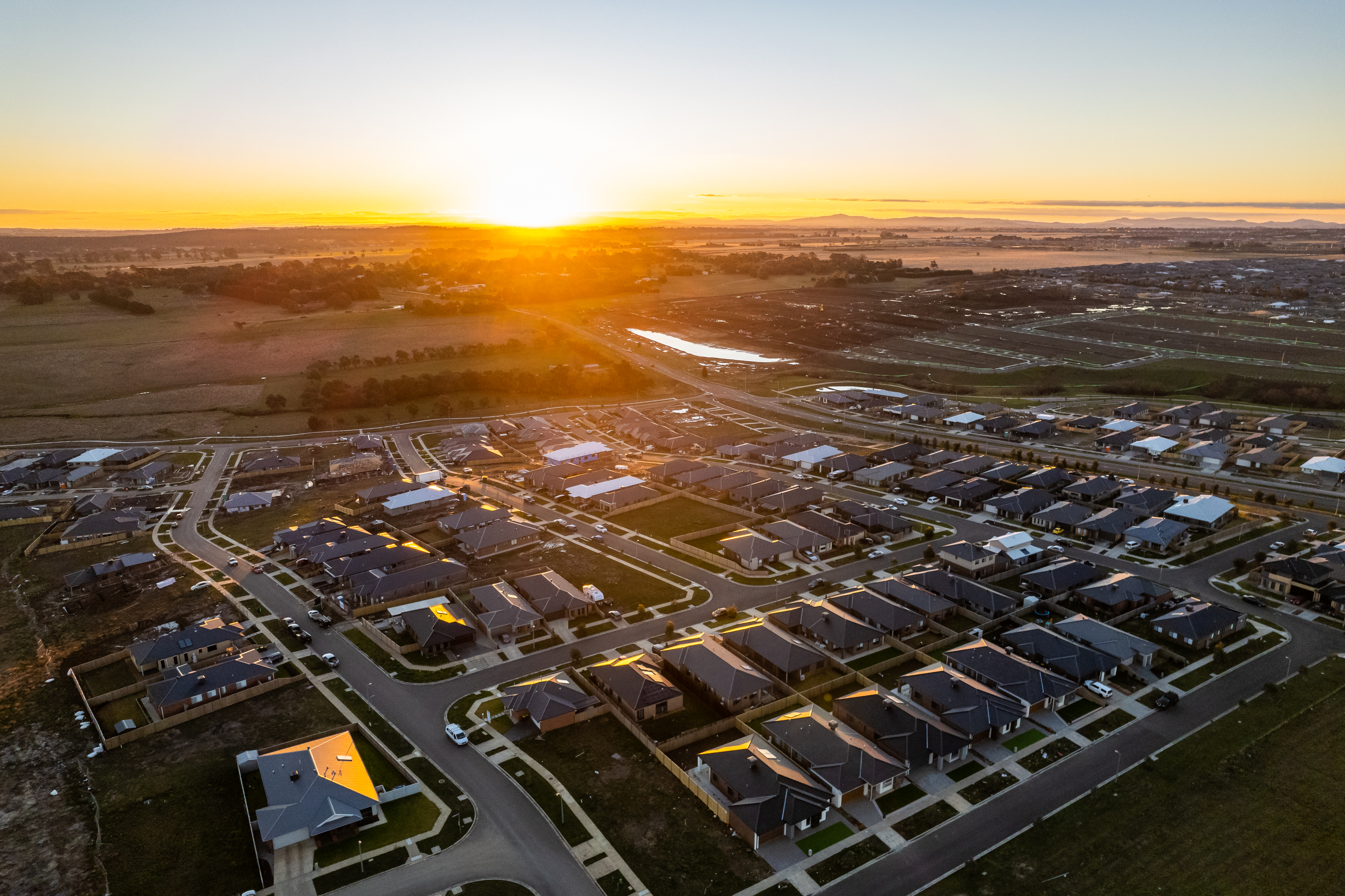 Generic photo drone shot of residential area at sunset 