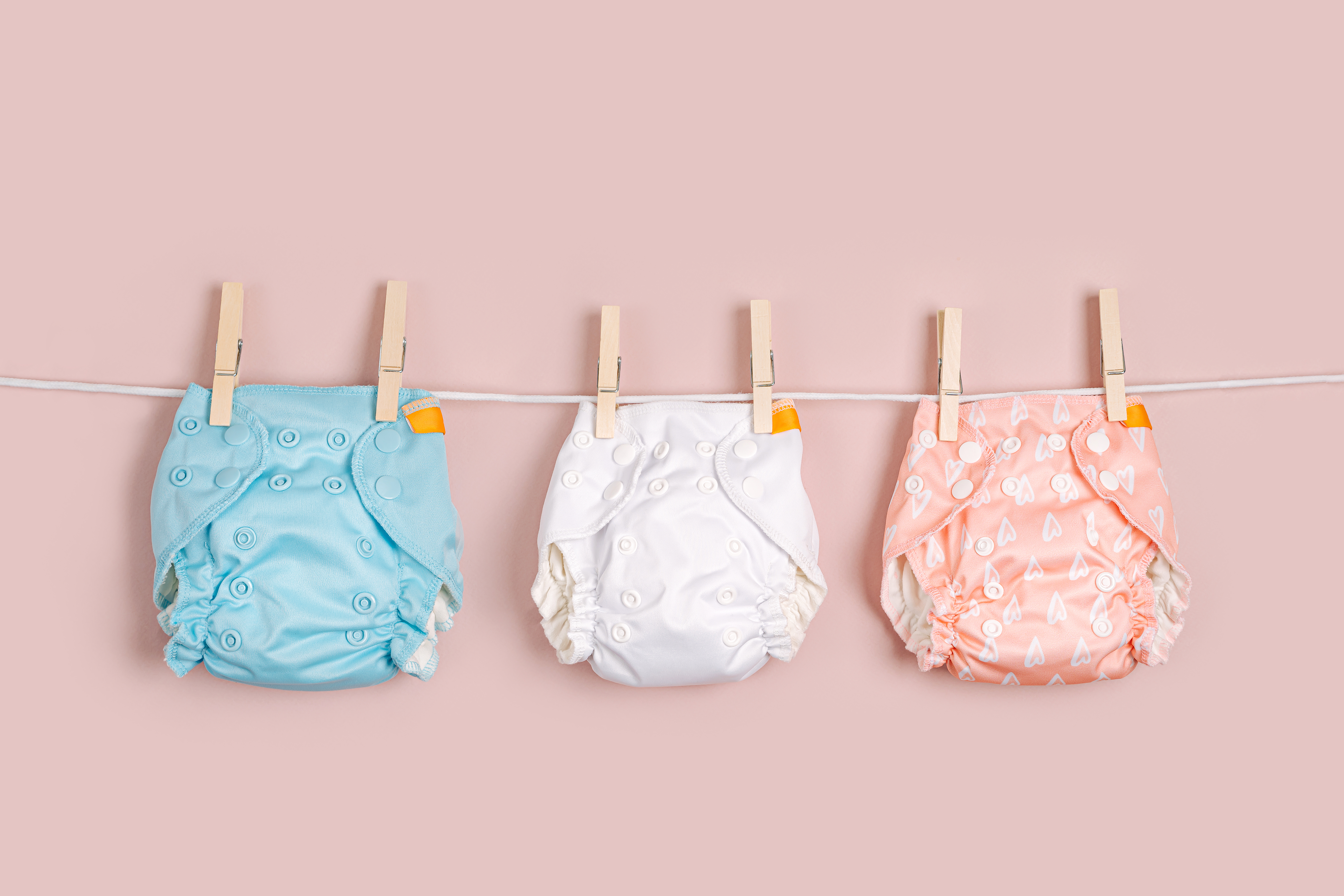 cloth reusable nappies hanging on a clothes line 