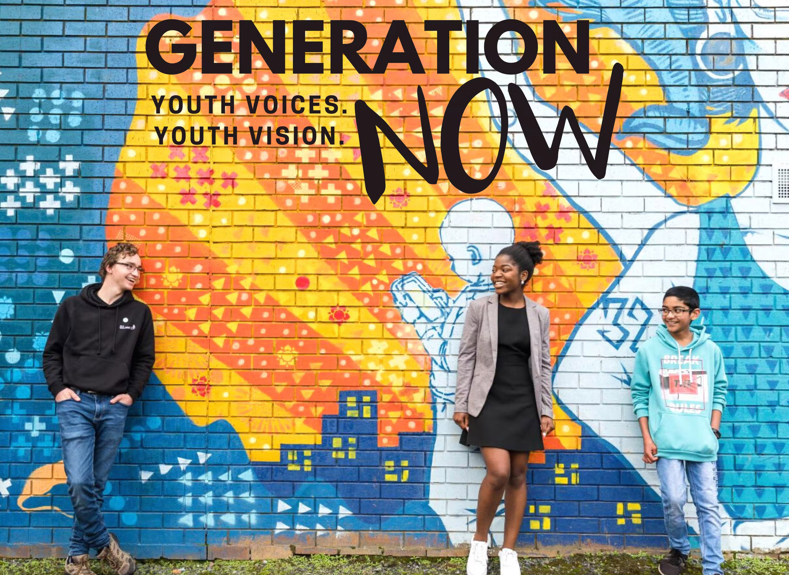 Three diverse young people leaning against a mural reading "generation now"