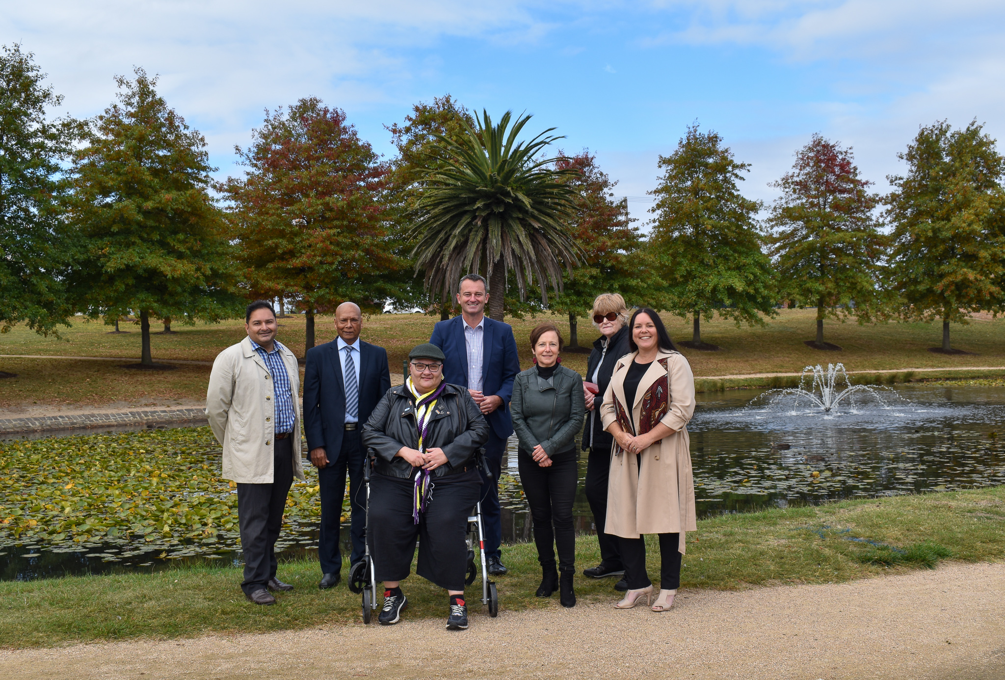 Generic photo group of people in front of a lake 