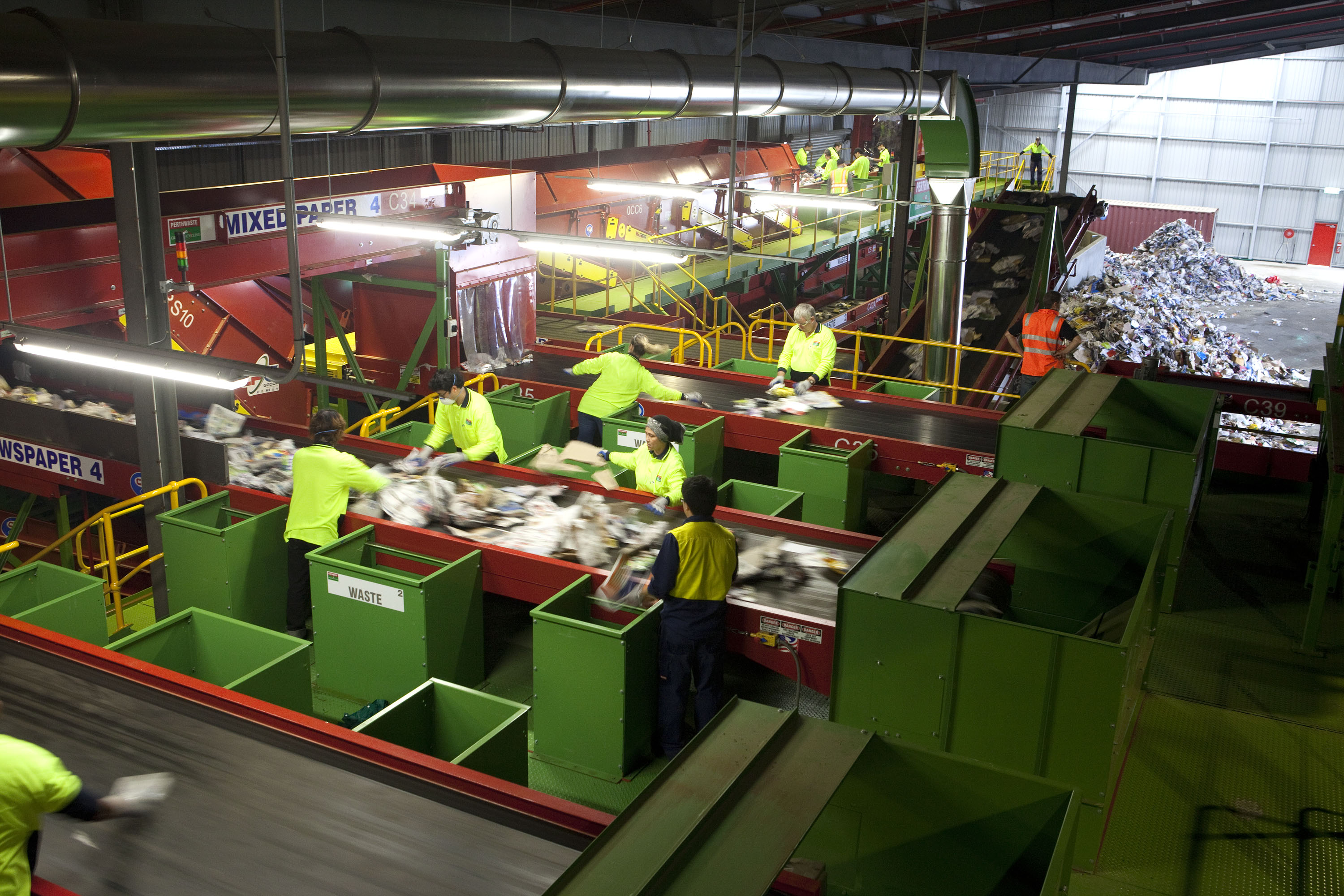Works sorting rubbish in a Materials Recovery Facility