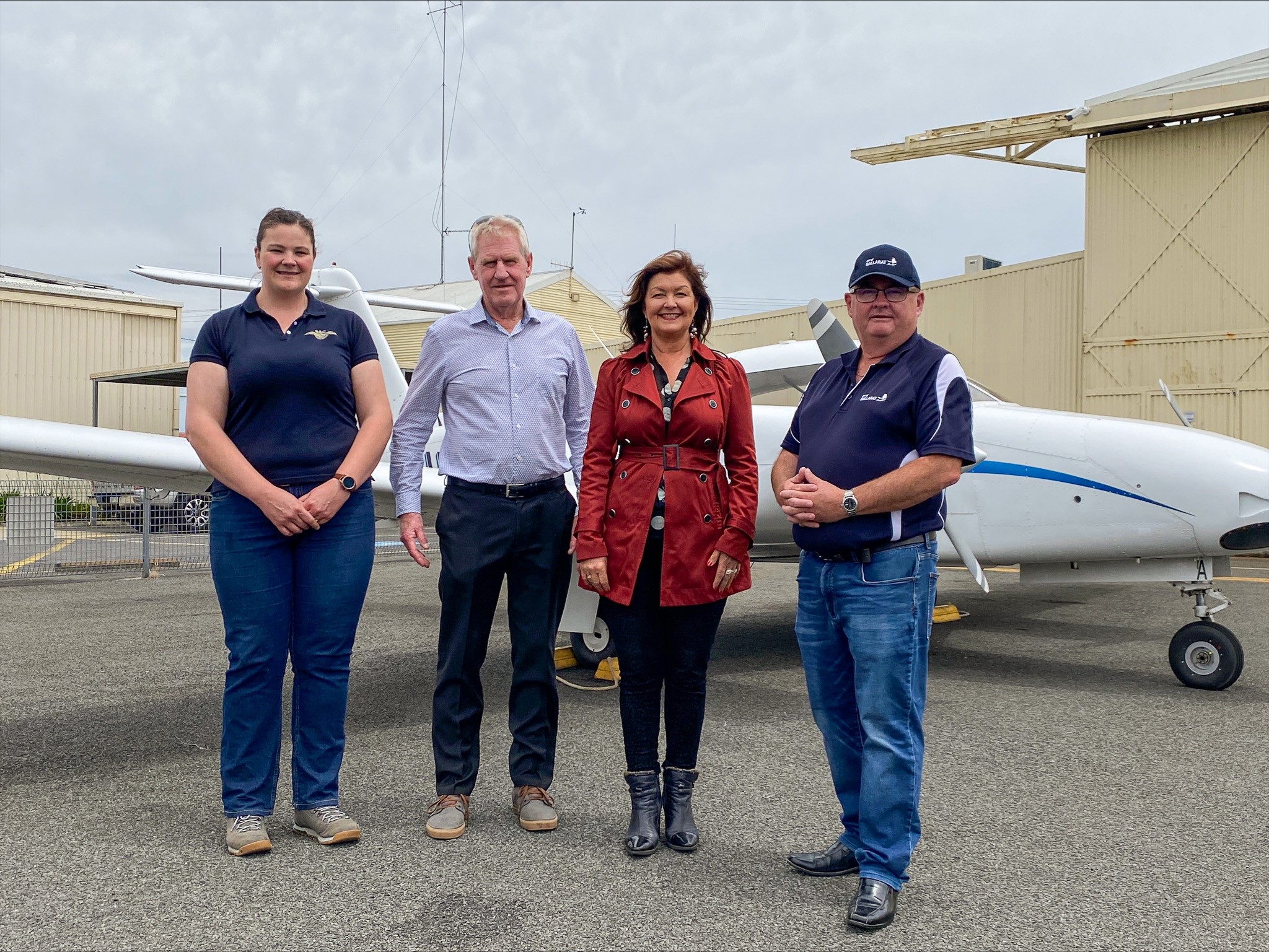 Generic photo group of people in front of an airplane 