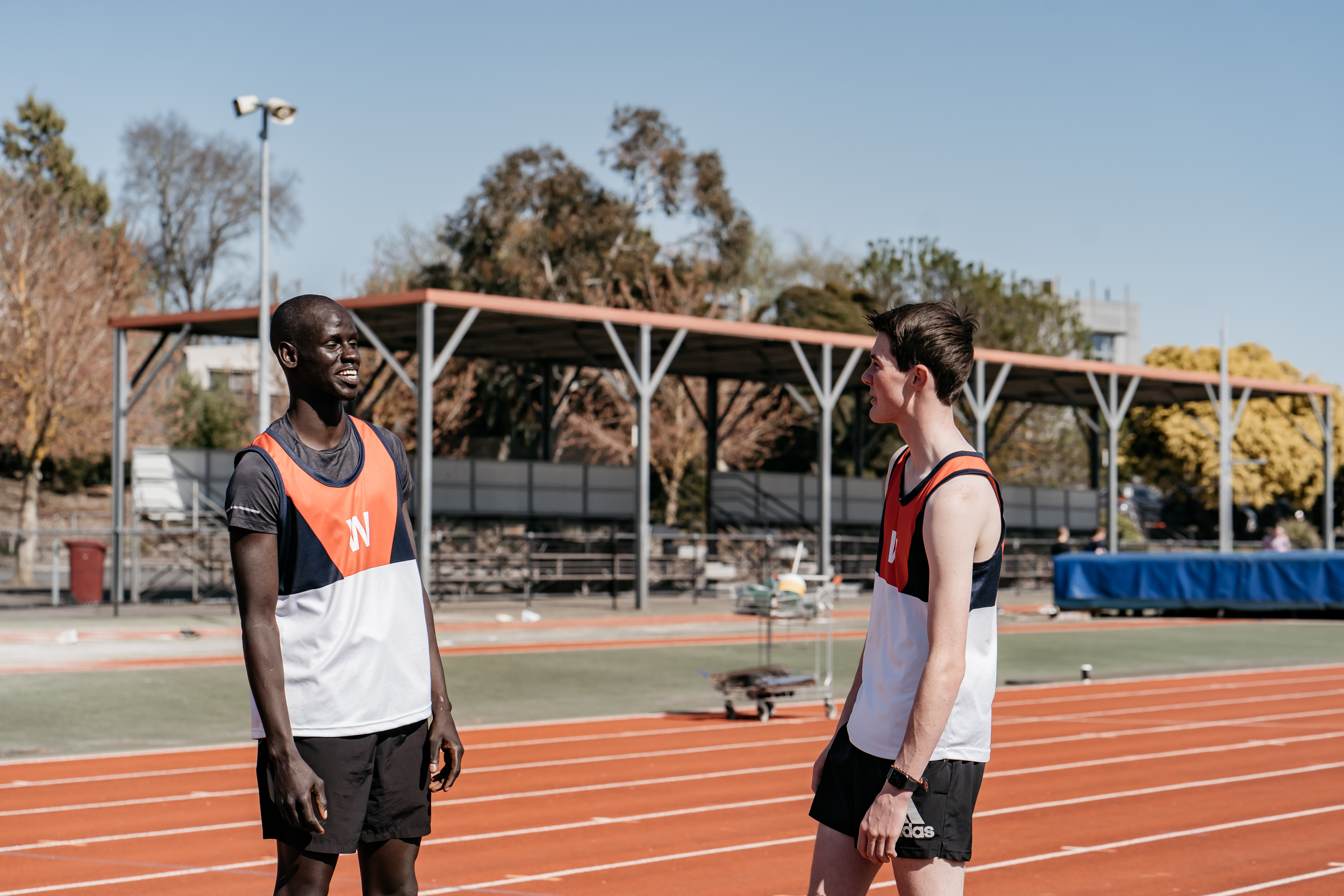two young men on an athletics running track