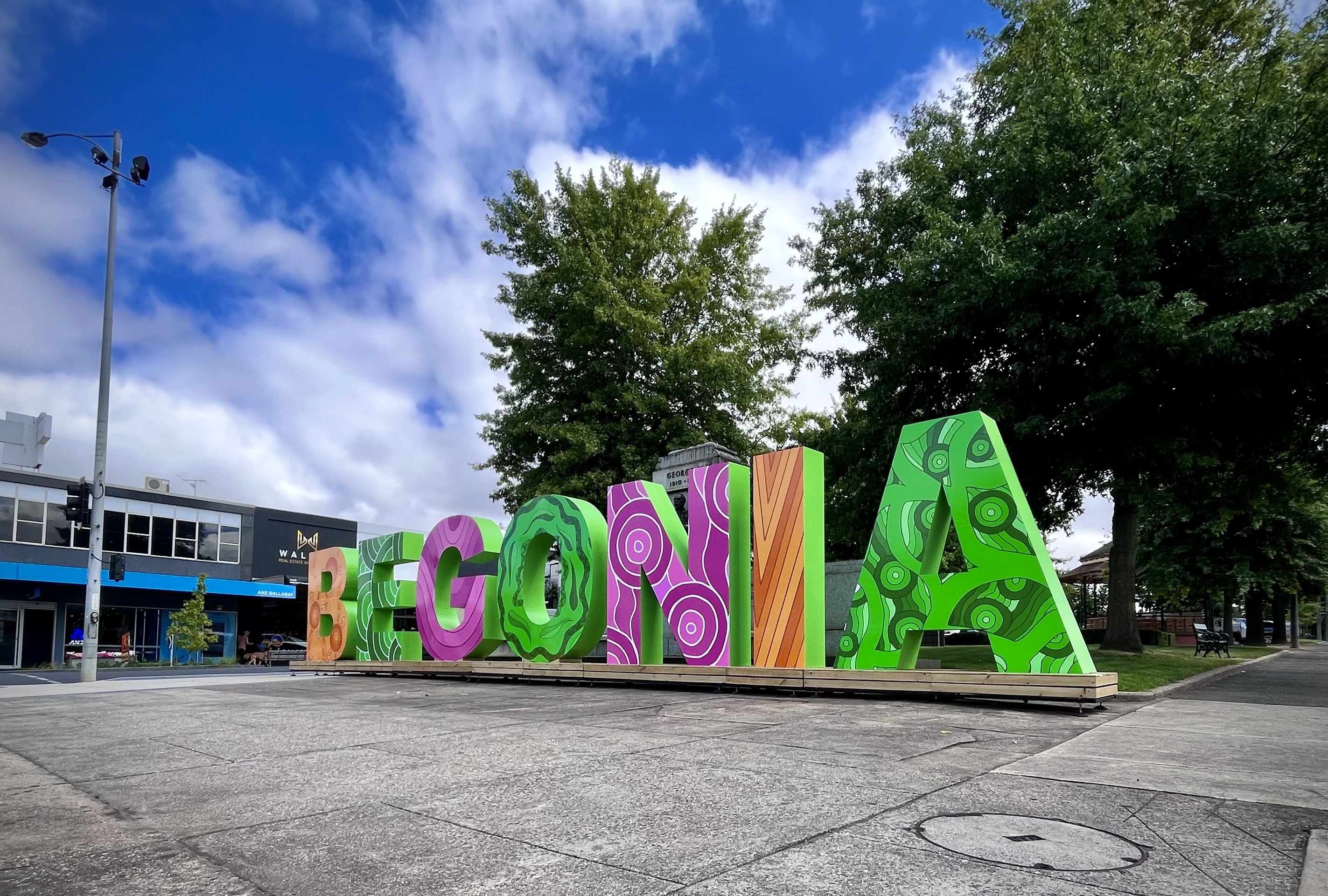 Large, bright letters spelling out 'Begonia' in the centre of Sturt Street. 