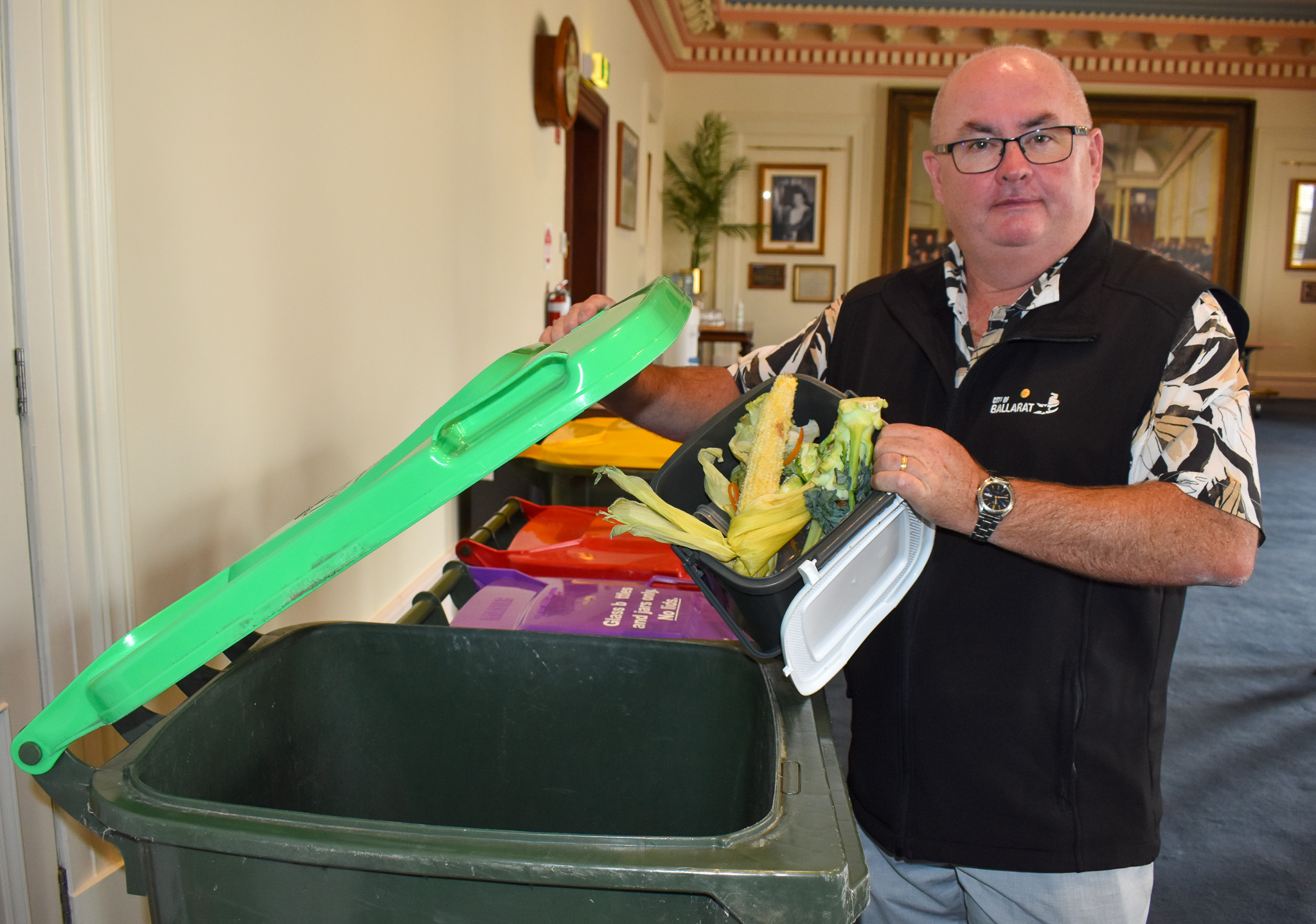 Mayor Des Hudson holding FOGO waste 