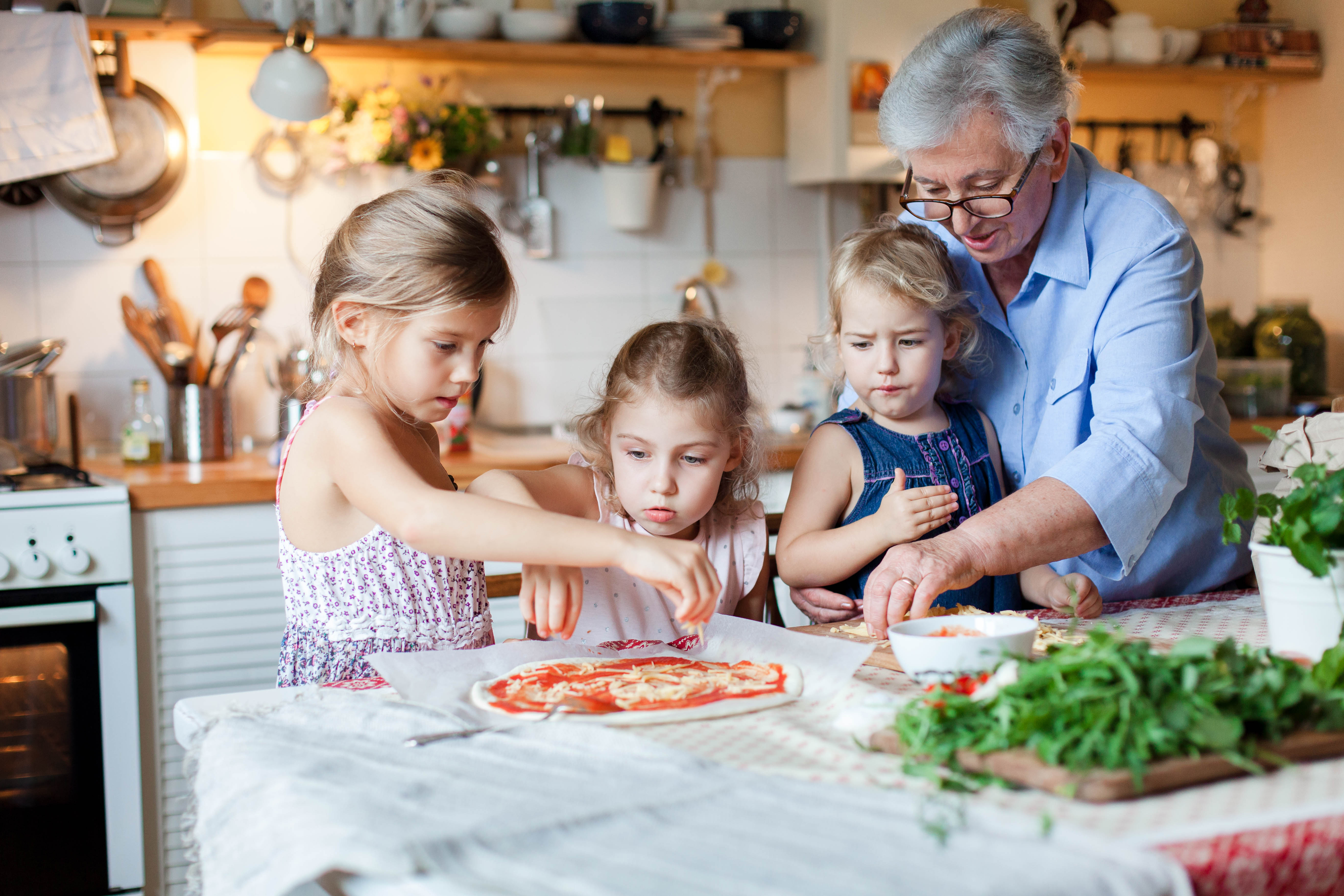 A grandmother baking with her grandchildren.