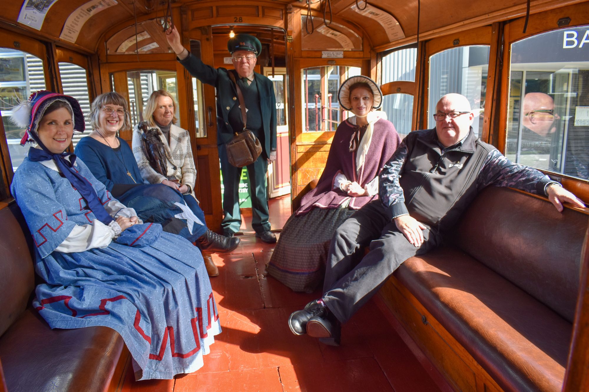 Mayor Des Hudson with Ballarat Tramway Museum conductor and women from Sovereign Hill and Craft Lab 23
