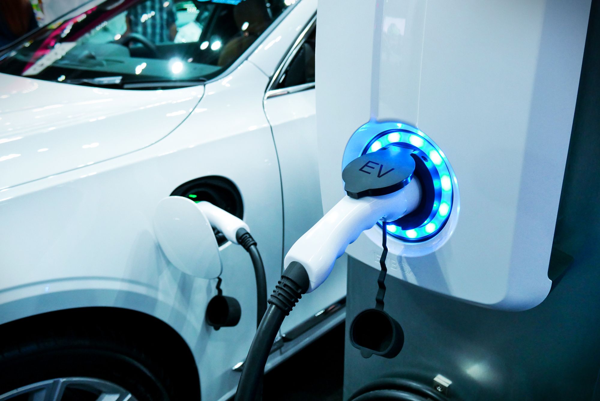 An electric vehicle is plugged into an electric vehicle charging station. 