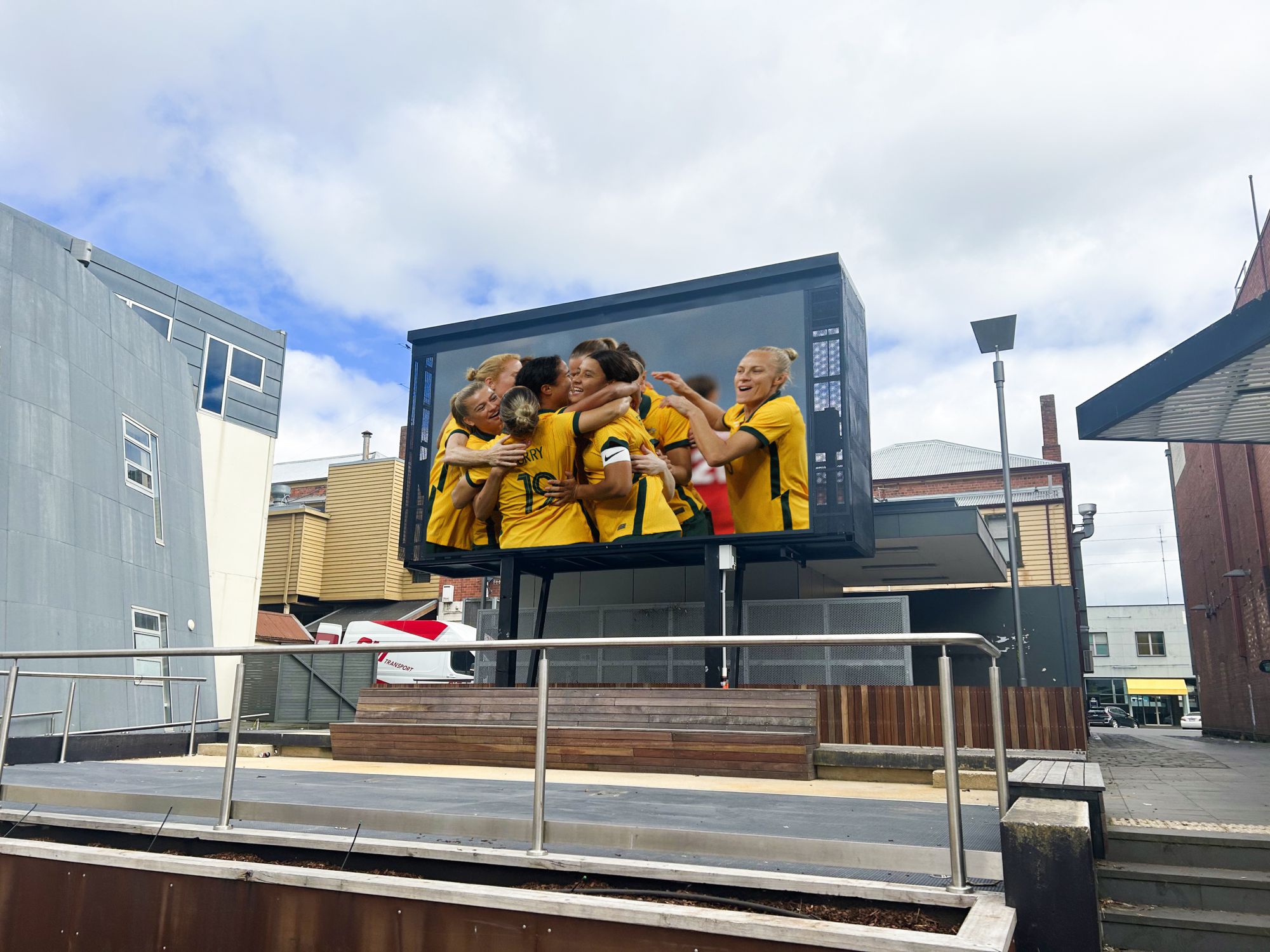 An altered image depicting the Matildas on the Alfred Deakin Place big screen.
