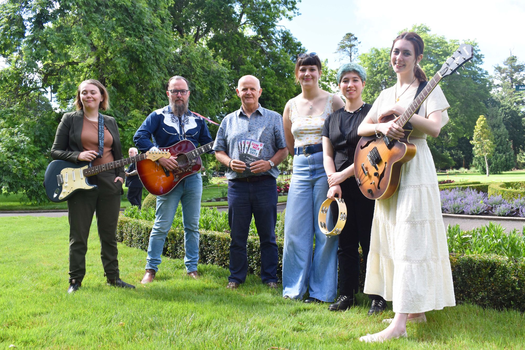 City of Ballarat Deputy Mayor, Cr Peter Eddy (centre) alongside some of the 2024 Summer Sundays musical acts, Rhiannon Simpson, Jeremy Beggs and The Pearlies in the Ballarat Botanical Gardens.