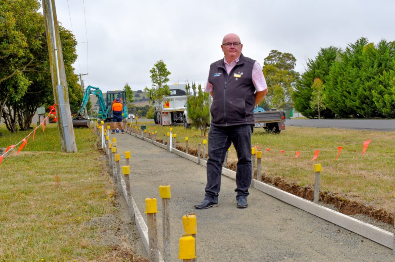 Mayor Cr Des Hudson at the site of a new footpath under construction