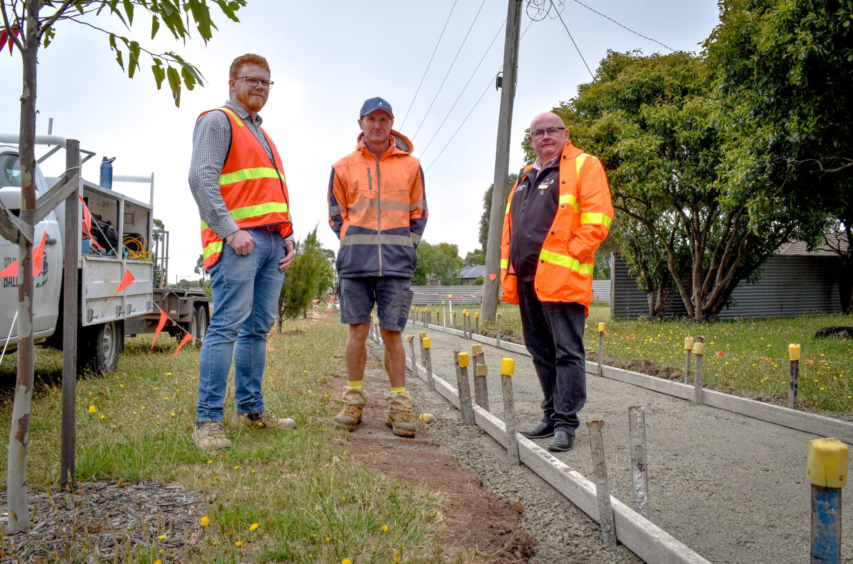 Mayor Cr Des Hudson with staff at the site of a footpath under construction