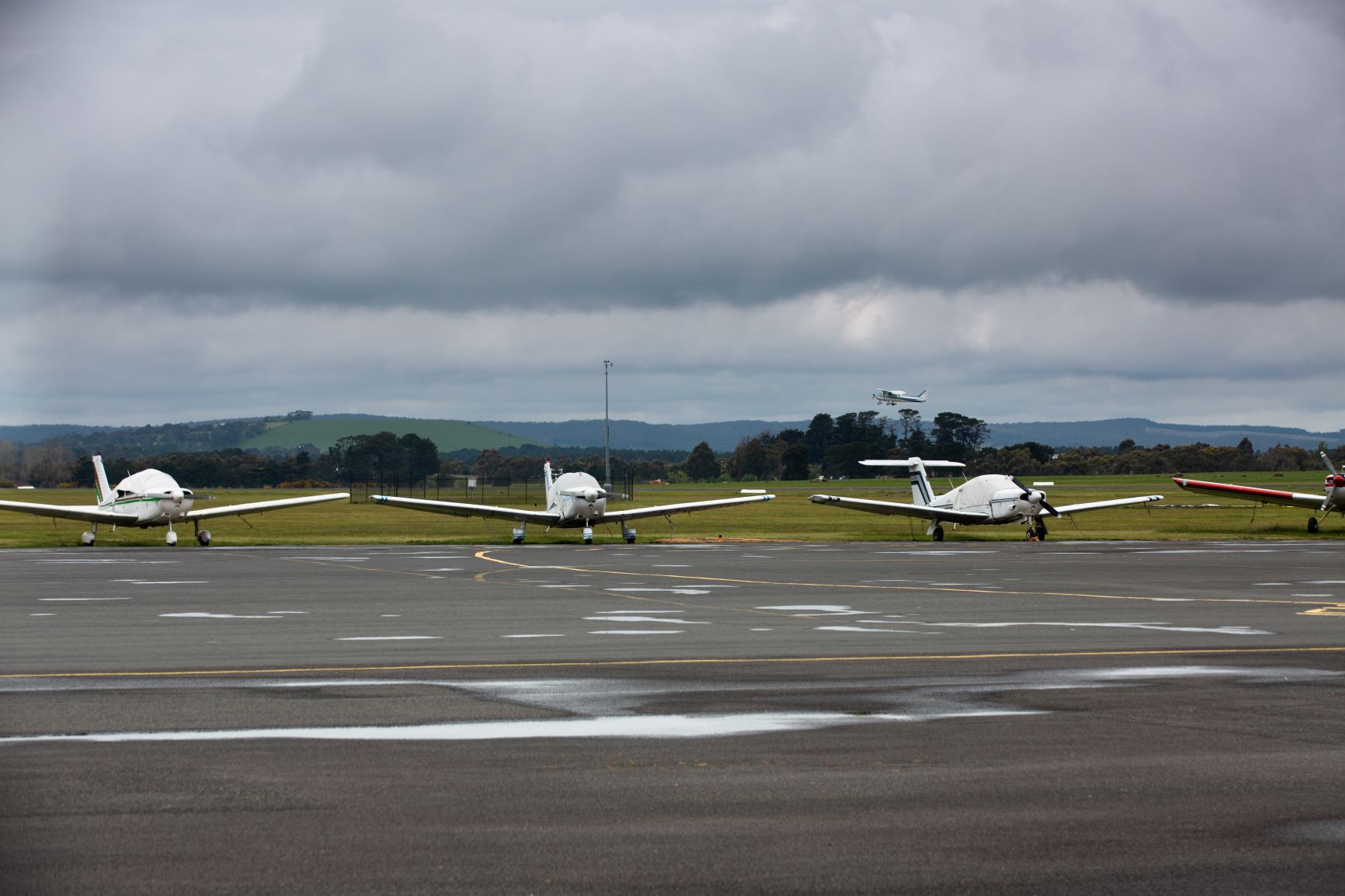 Planes on the tarmac and one taking off at Ballarat Airport 