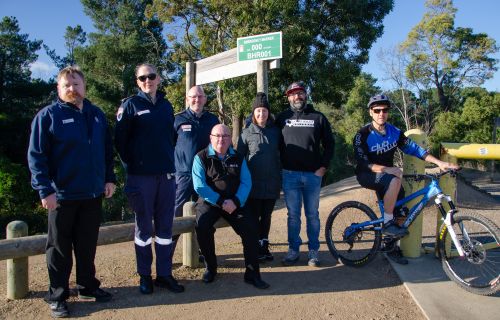 Cr Des Hudson with Ambulance Victoria and members of the mountain biking club