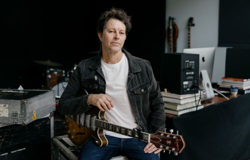 Bernard Fanning holding a guitar