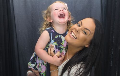 Woman holding Child laughing