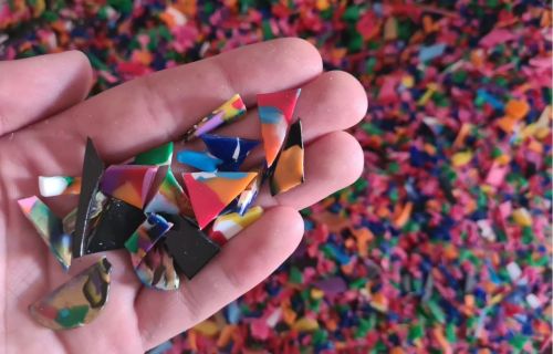 Generic photo hand holding colourful plastic