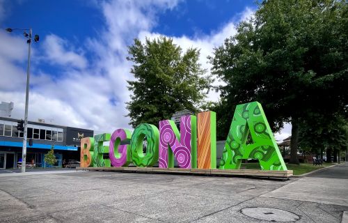 Large, bright letters spelling out 'Begonia' in the centre of Sturt Street. 