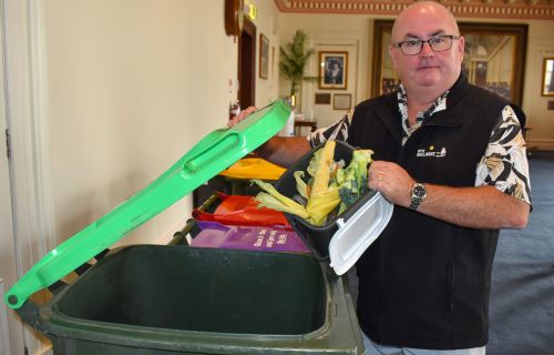 Mayor Des Hudson holding FOGO waste 