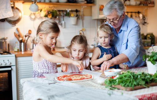 A grandmother baking with her grandchildren.