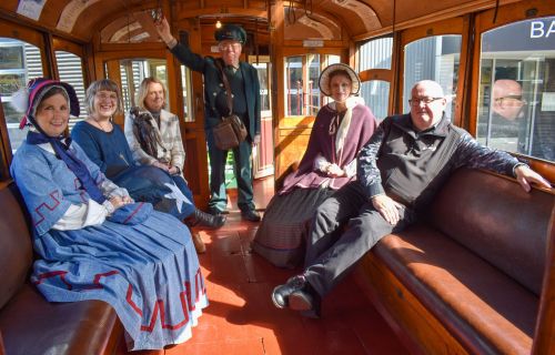 Mayor Des Hudson with Ballarat Tramway Museum conductor and women from Sovereign Hill and Craft Lab 23