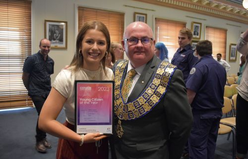 Photo of Mayor Cr Des Hudson with Young Citizen of the Year winner 2023 holding up a framed certificate