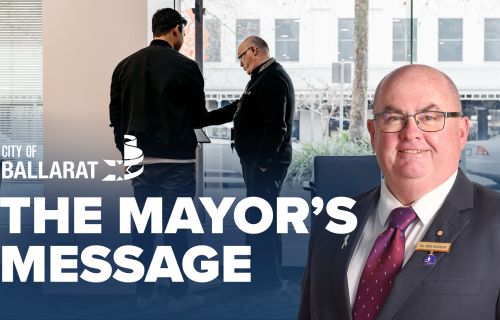 Text with The Mayor's Message with an image of Mayor Cr Des Hudson in front of a drop-in meeting