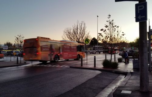 Little Bridge Street at sunset with a bus in background