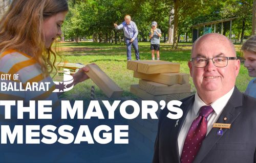 Text with The Mayor's Message with an image of Mayor Cr Des Hudson in front of a picnic in a park