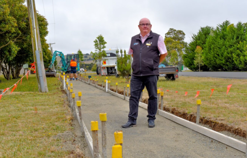 Mayor Cr Des Hudson at the site of a new footpath under construction
