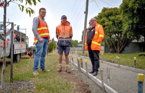 Mayor Cr Des Hudson with staff at the site of a footpath under construction