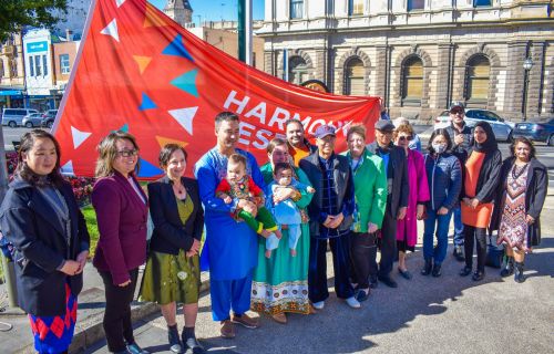 The Harmony Day flag raising in Queen Victoria Square.