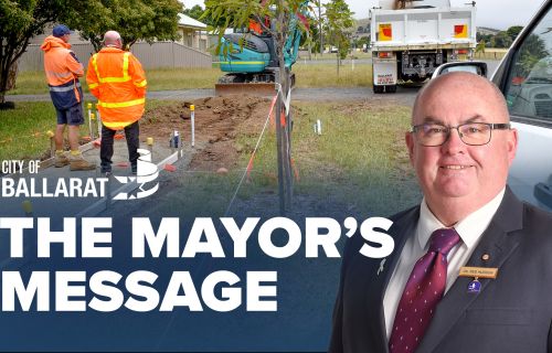 Text with The Mayor's Message with an image of Mayor Cr Des Hudson in front of footpath construction