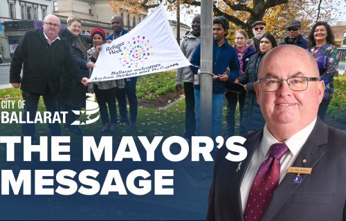 Text with The Mayor's Message with an image of a group at the flag raising for World Refugee Day