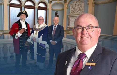 An image of Mayor Cr Des Hudson in front of a photo after Cr Des Hudson was elected as the returning City of Ballarat Mayor and Cr Peter Eddy as Deputy Mayor for the 2023/24 term. 