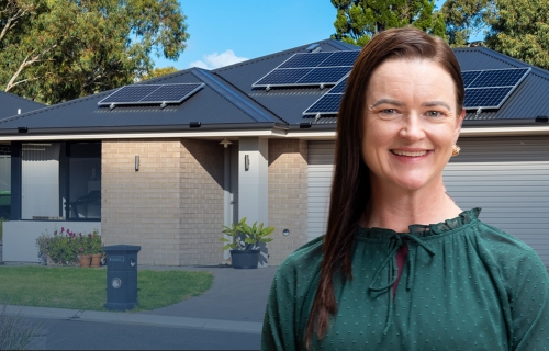 Image of Mayor Cr Tracey Hargreaves in front of a residential home with solar panels