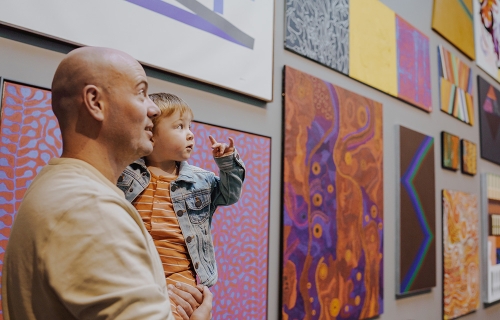 A man and young child looking at artwork in the Art Gallery of Ballarat.