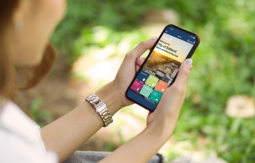 image of a person on their phone looking at the Ballarat Waste App