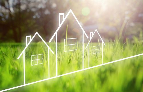 Outline of houses with green grass