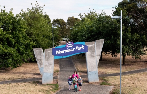 Aerial image of Weermar Park and kinder teacher and children standing at the entrance imagining the future library