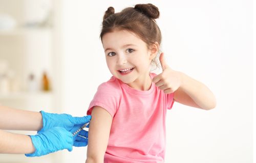 Young girl receiving an injection.