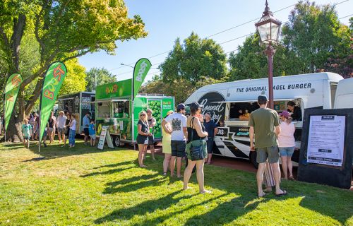 Customers being served by food trucks