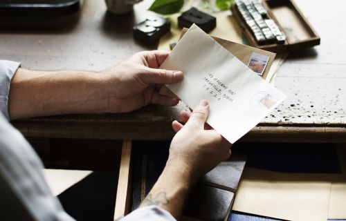 Person holding envelop