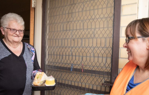 Spreading kindness: Dawn Carpenter receives her Meals on Wheels delivery and has a chat with City of Ballarat Community Care Worker Deborah Barnett.