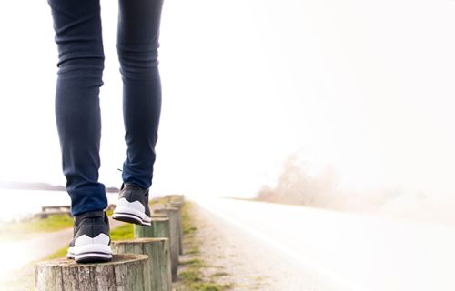 Person walking along logs