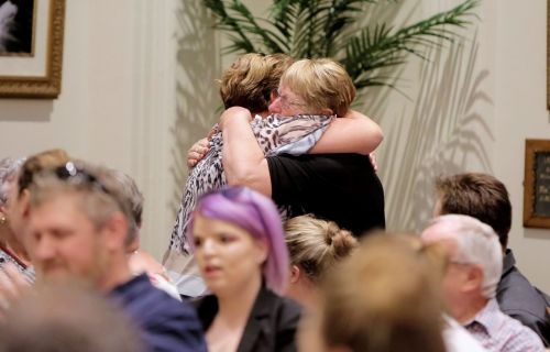 two people hugging in a crowd