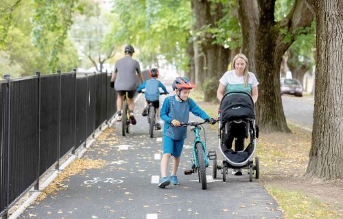 Families using a shared path with bikes and a pram