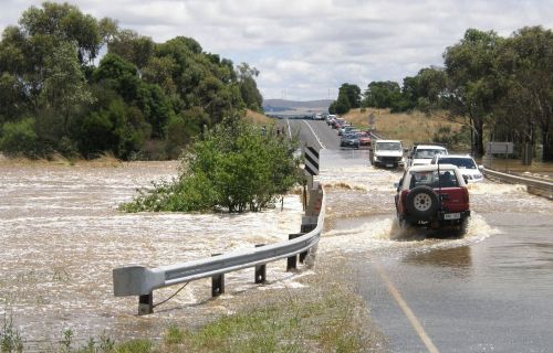 Cars crossing a flooded road